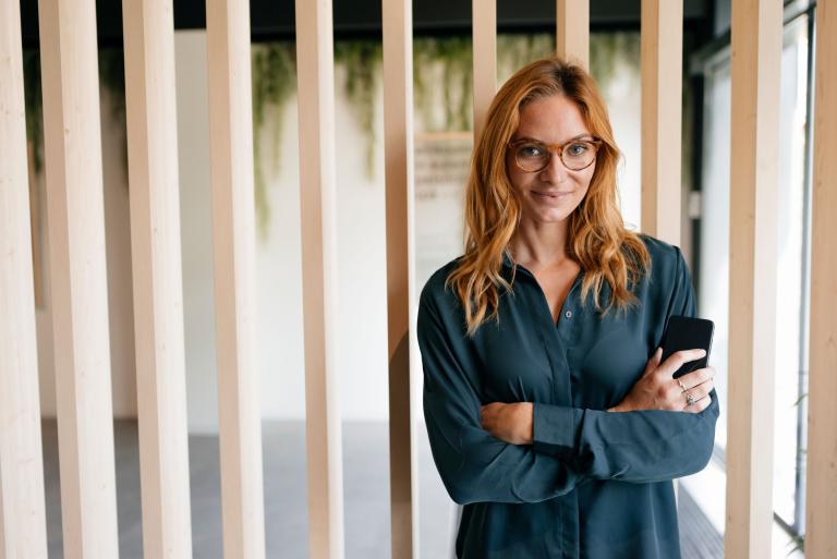 Frau verschränkte Arme vor Holzpanel
