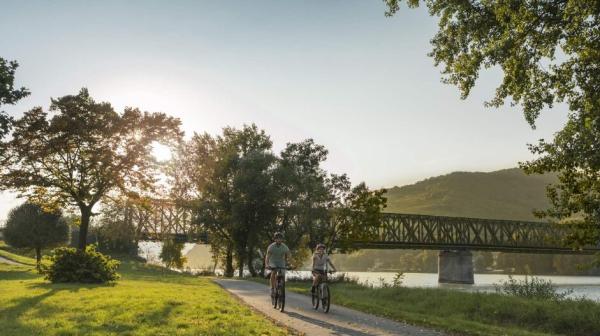 Zwei Radfahrer auf einem betonierten Radweg